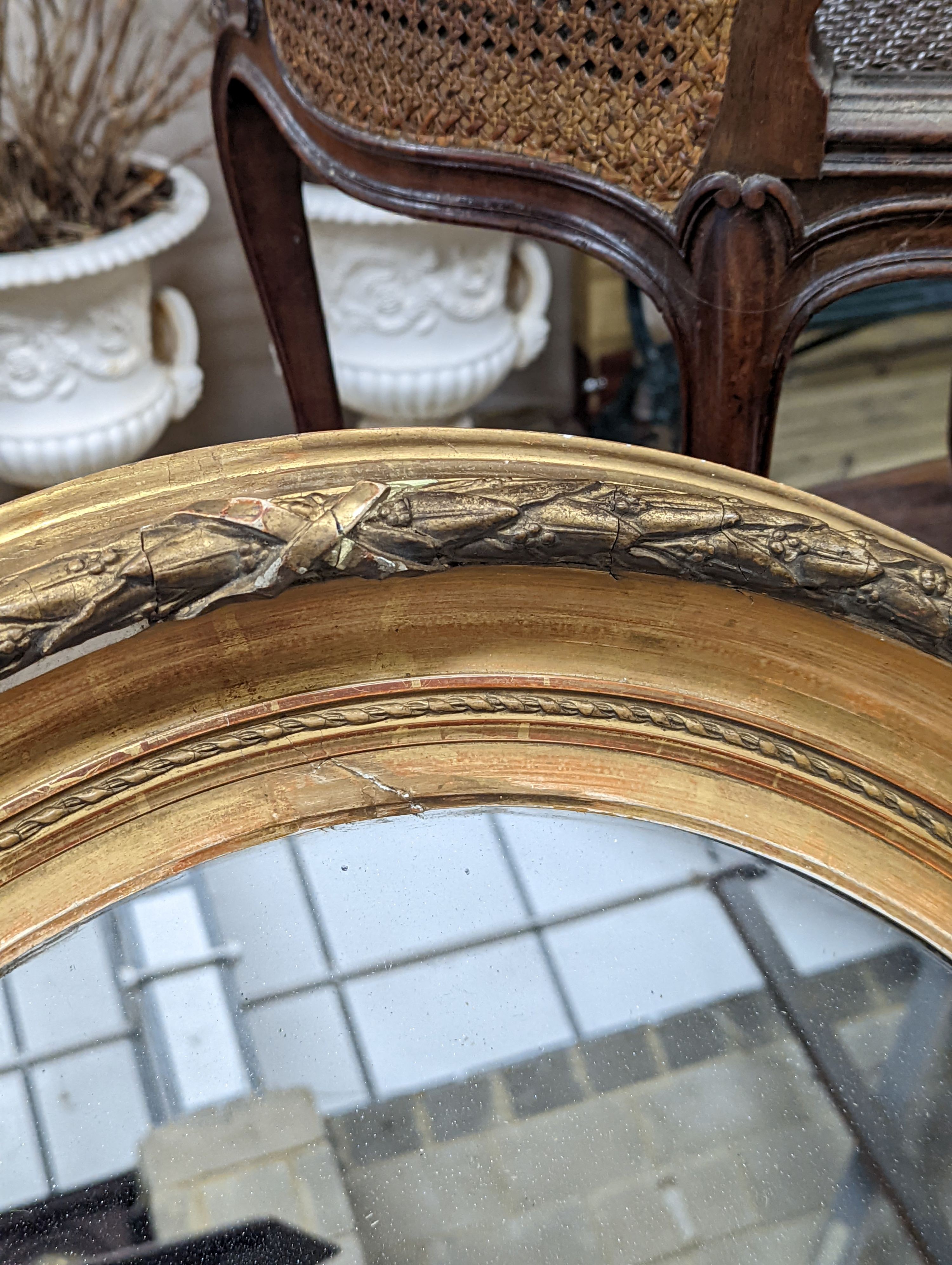 A Victorian oval giltwood and gesso wall mirror, width 80cm, height 94cm